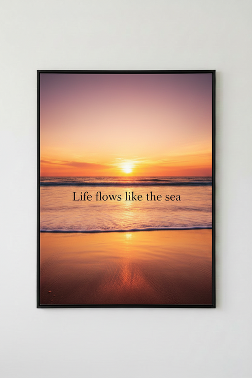 Framed artwork with a sunset over water and the text 'Life flows like the sea' on a white wall.